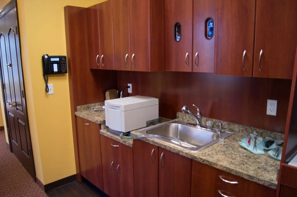 Clean sterilization and lab area with wood cabinetry